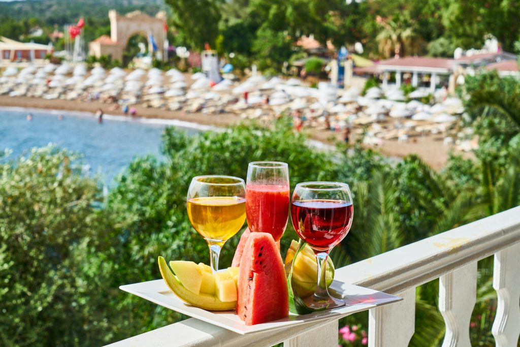 An image of wine glasses and fruits in a plate at a hotel balcony depicting adults only hotels in Salzburg