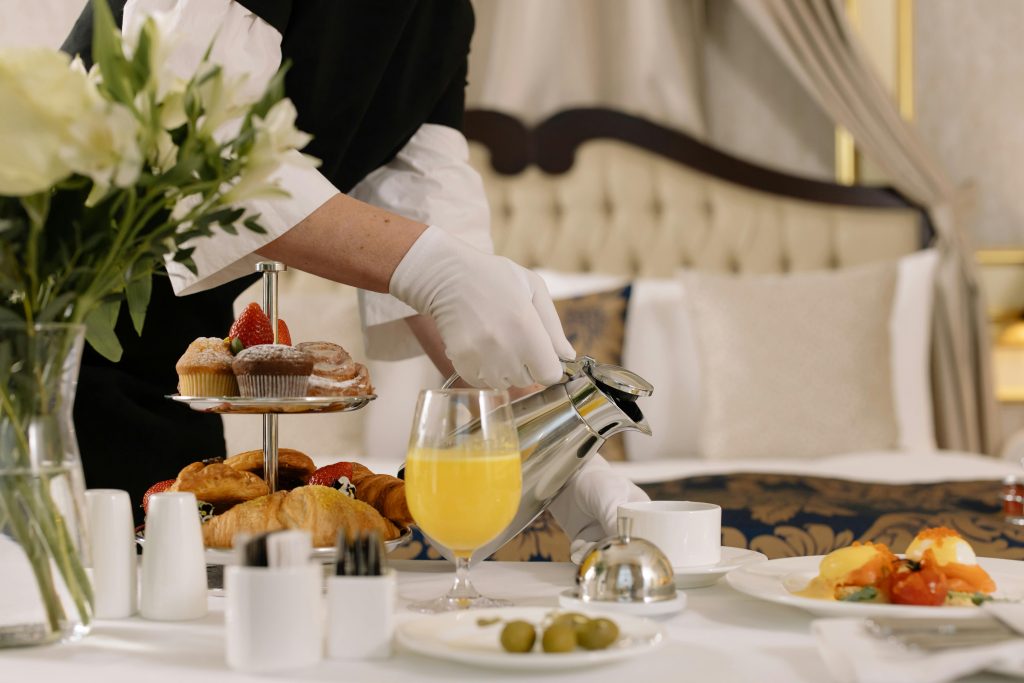 An image of a waiter serving meal at one of the top bed and breakfast hotels in Linz