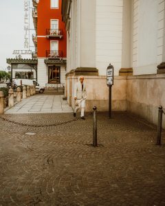 An image of a hotel with a passerby at one of the 4-star adults-only hotels in Klagenfurt