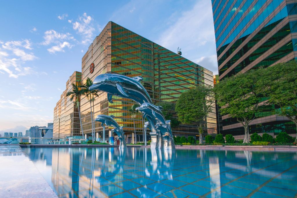 An image of one of the top all-inclusive hotels in Innsbruck with swimming and dolphins sculptures in front of it.