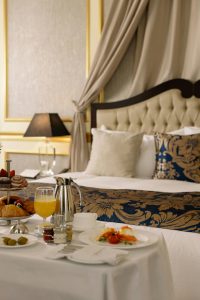 An image of breakfast table and a bed at the back in one of the best bed & breakfast hotels in Austria